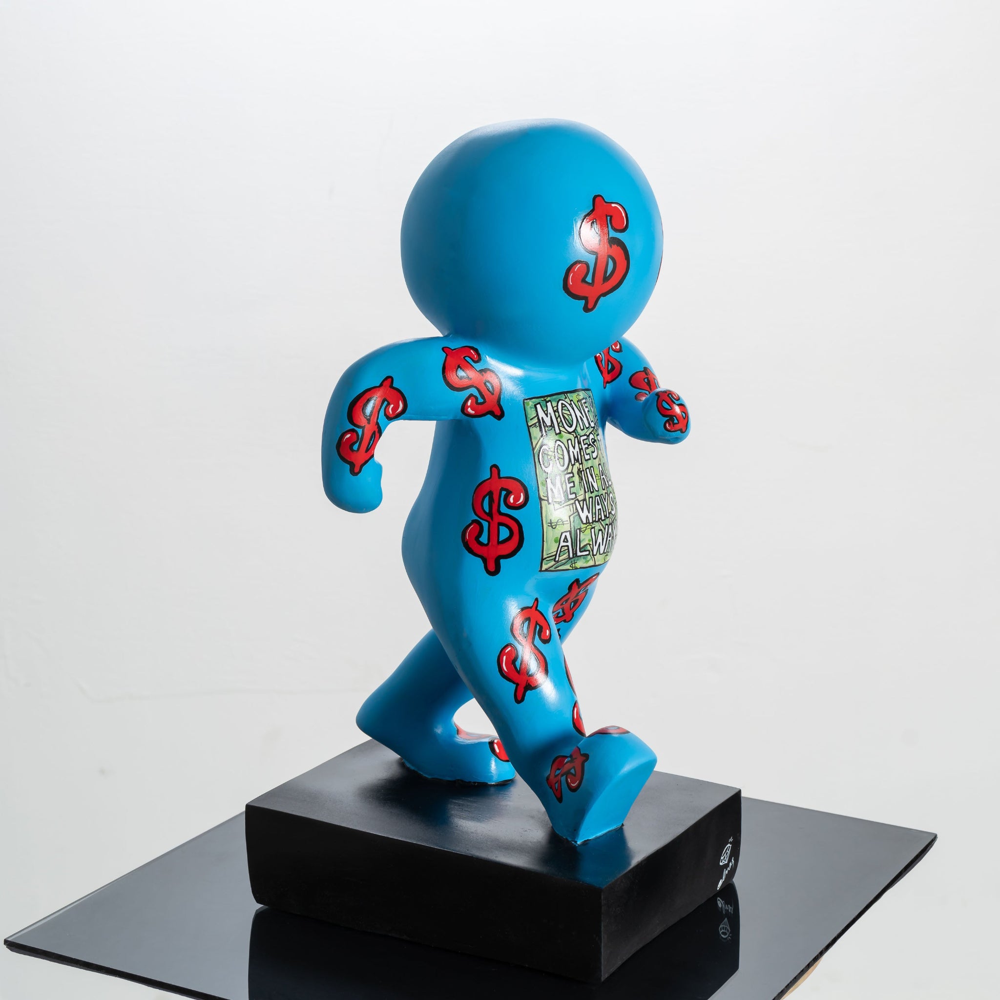 Blue figurine with red dollar signs on a black base against a white background